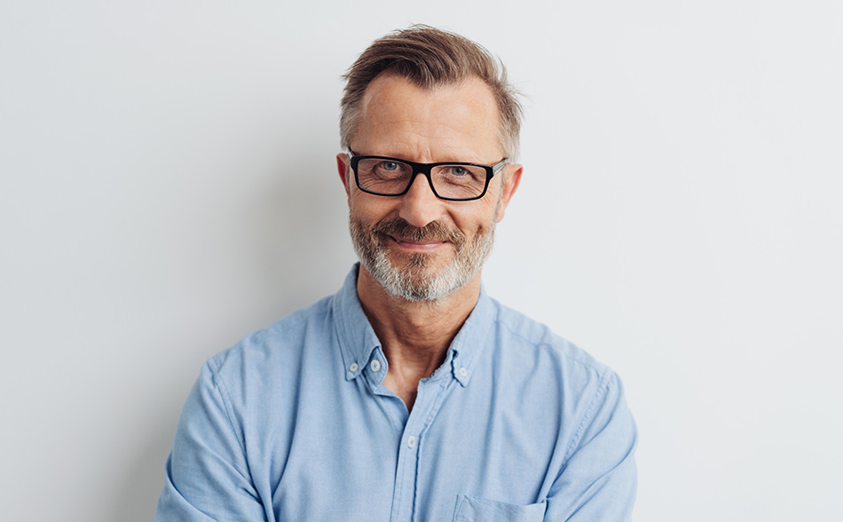 Middle-aged man smiling confidently, representing general dentistry and healthy smile results