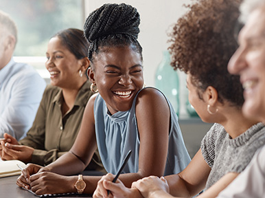 Group of adults smiling and chatting, representing welcoming dental office and positive patient experience